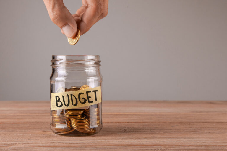Budget.,Glass,Jar,With,Coins,And,An,Inscription,Budget